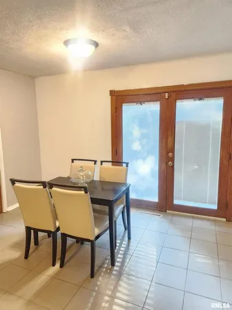 a view of a dining room with furniture and a chandelier
