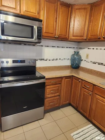a kitchen with granite countertop cabinets and steel stainless steel appliances