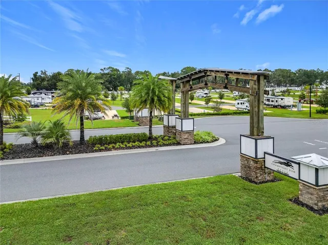 a view of a house with a yard and potted plants