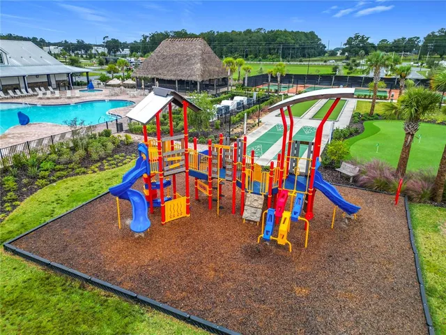 an aerial view of a swimming pool with a yard