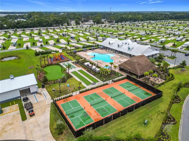 an aerial view of residential houses with outdoor space and river