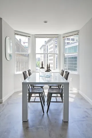 a dining room with furniture and window