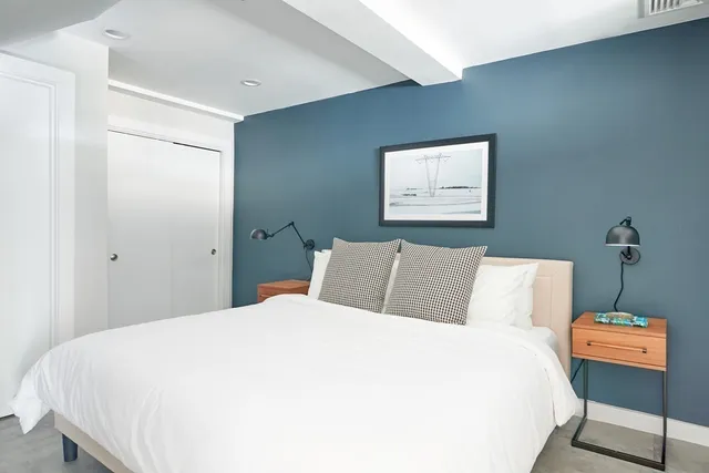 a bedroom with a bed and a night stand