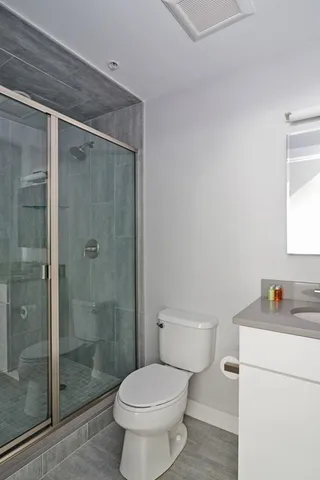 a white toilet sitting next to a bathroom sink