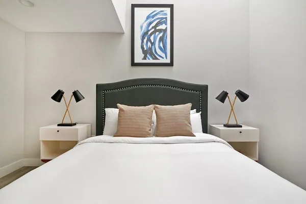 a bedroom with a bed and a night stand