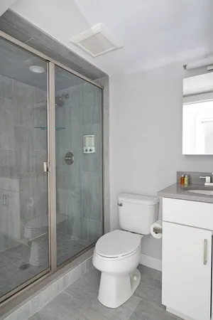 a bathroom with a toilet and a shower