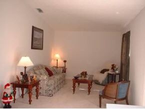 223 Northwest Rheine, Unit 48 Palm Bay, FL 32907 - Photo 2 of 10 a living room with furniture and a lamp