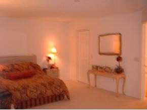 223 Northwest Rheine, Unit 48 Palm Bay, FL 32907 - Photo 9 of 10 a bedroom with a bed and a night stand