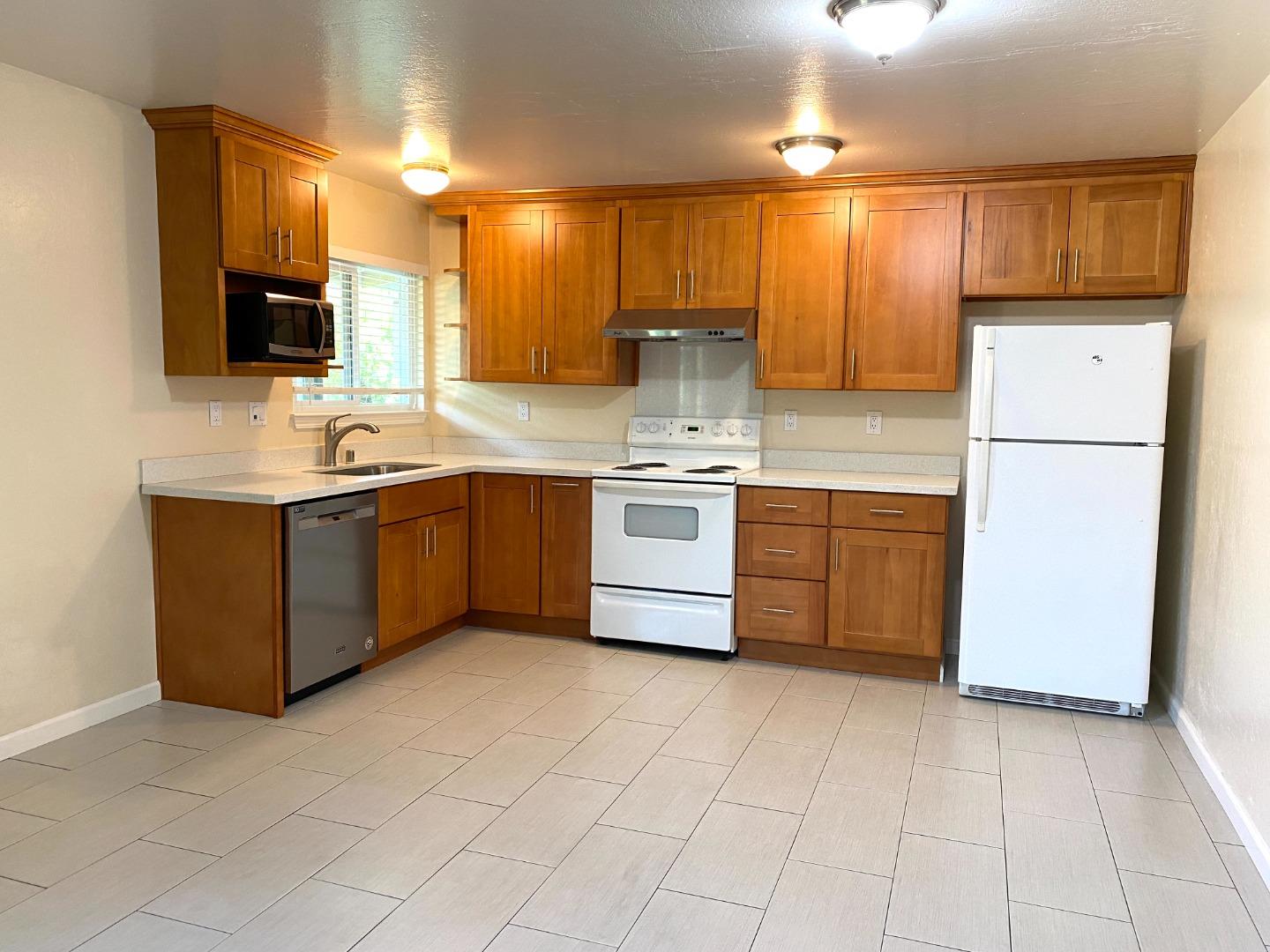 1242 Cortez Drive Sunnyvale, CA 94086 - Photo 20 of 31 a kitchen with a sink appliances and cabinets