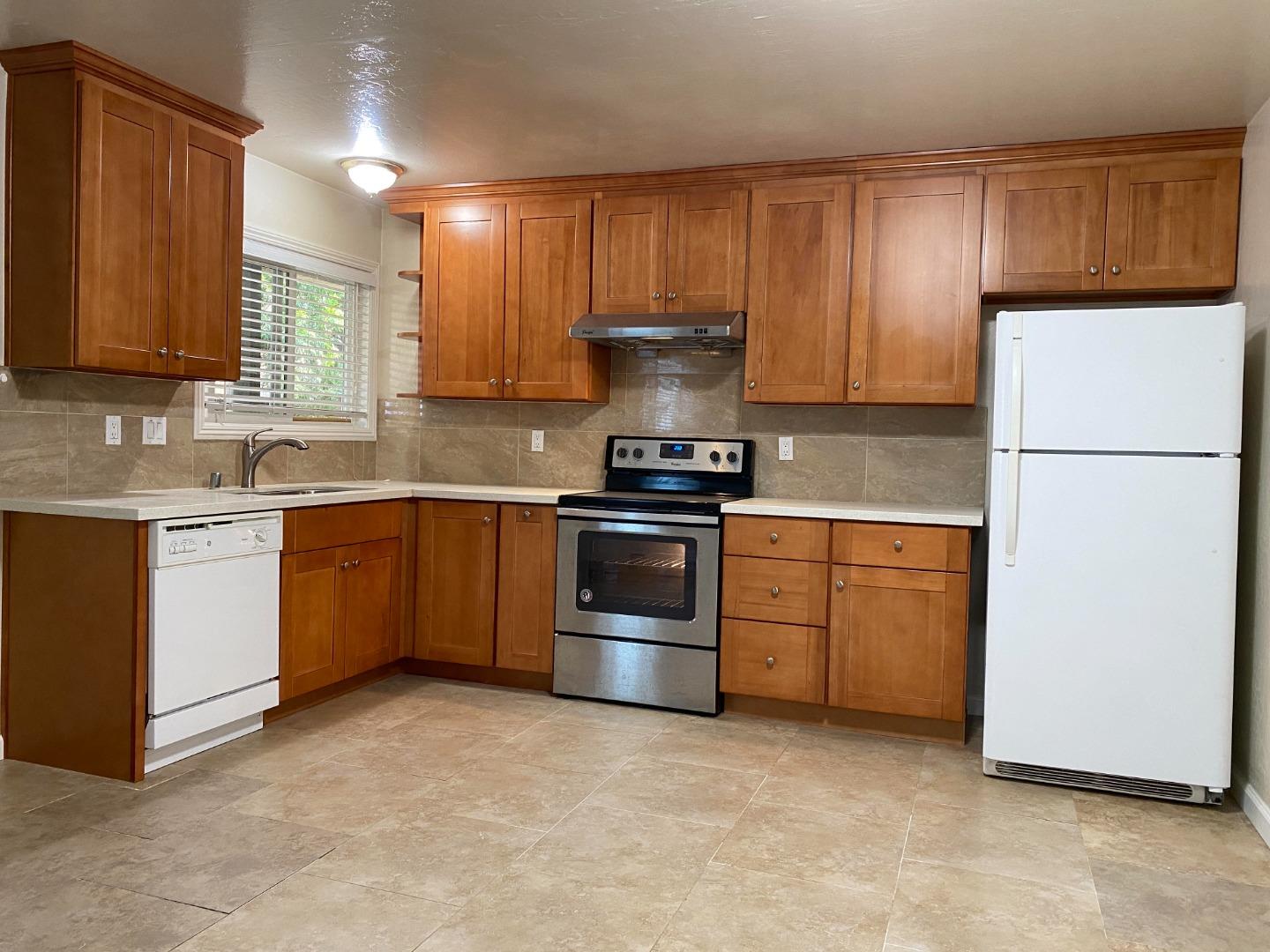 1242 Cortez Drive Sunnyvale, CA 94086 - Photo 9 of 31 a kitchen with a stove top oven sink and refrigerator