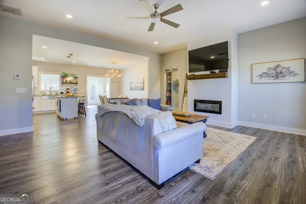 a living room with a bed furniture and a flat screen tv