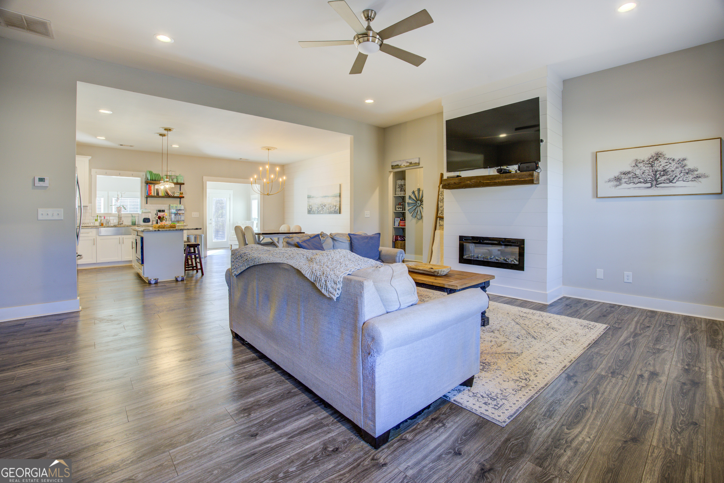3320 Davis Academy Road Rutledge, GA 30663 - Photo 17 of 45 a living room with furniture a flat screen tv and kitchen view