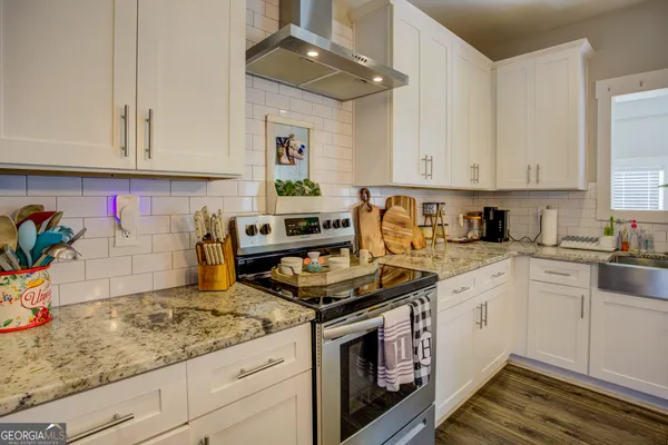 a view of a refrigerator in kitchen and wooden floor