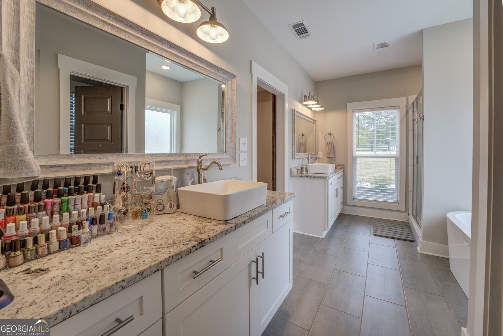 3320 Davis Academy Road Rutledge, GA 30663 - Photo 31 of 45 a spacious bathroom with a granite countertop sink and a mirror