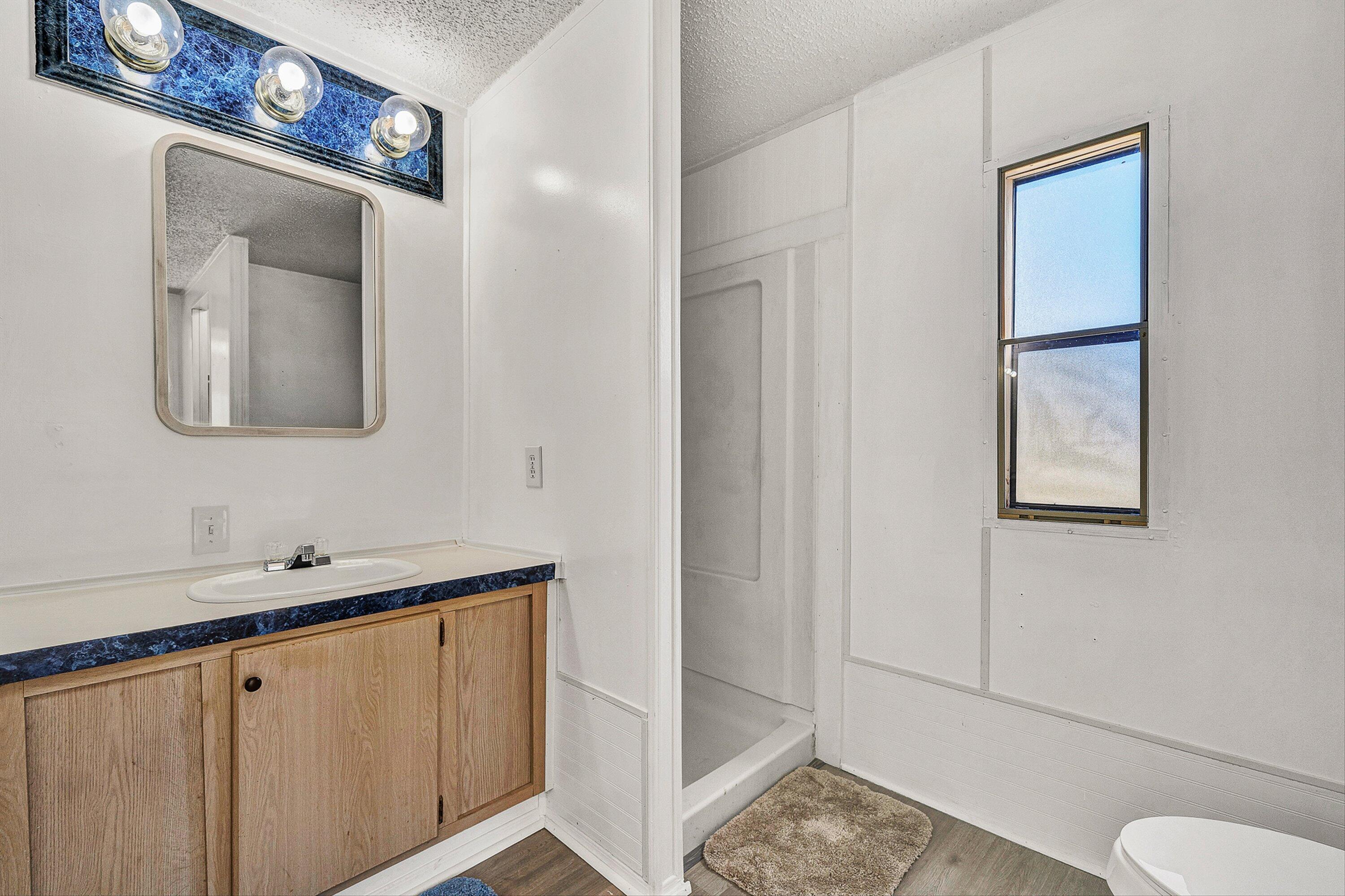 1155 Stonewall Road Blue Ridge, VA 24064 - Photo 13 of 43 a bathroom with a toilet sink and mirror