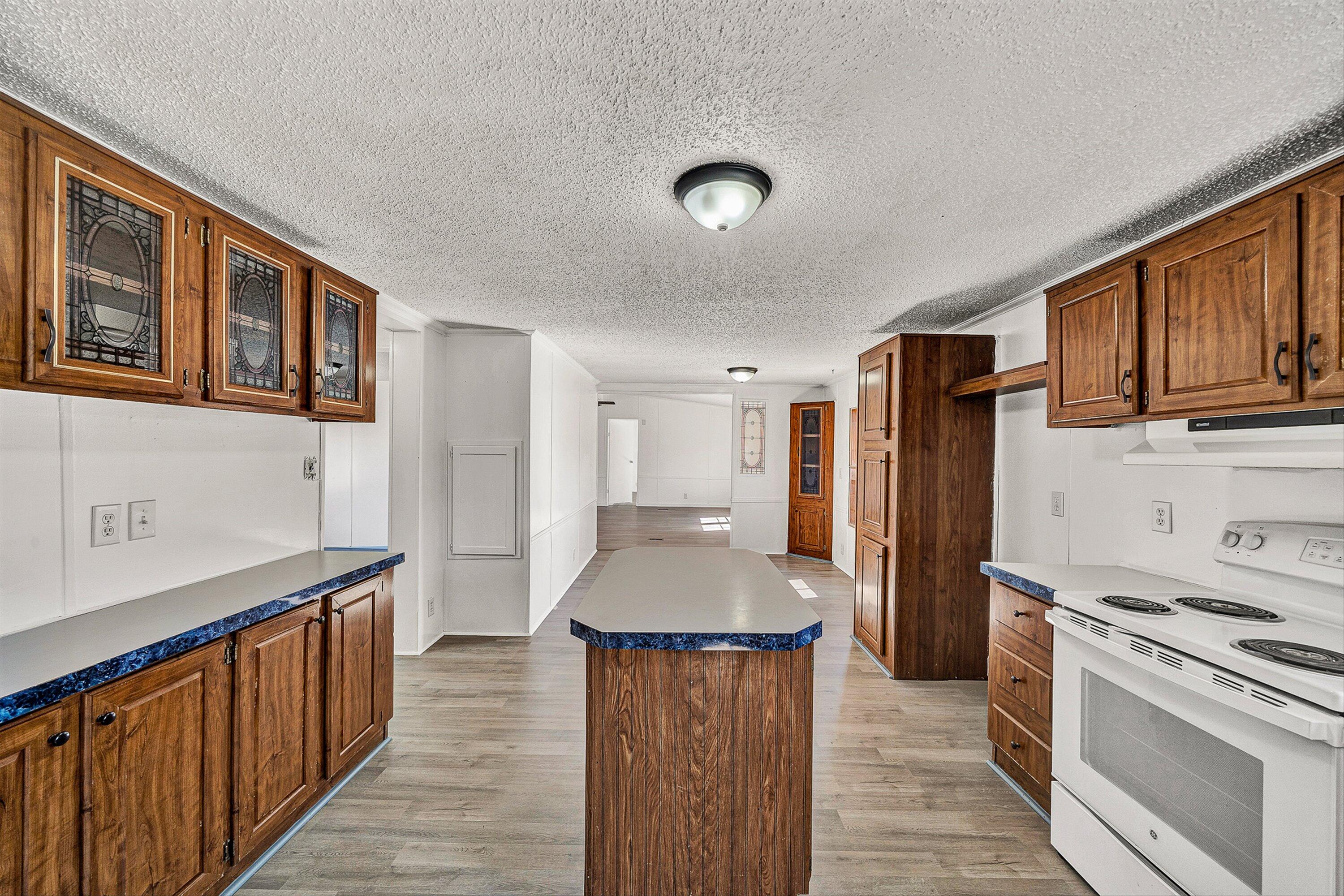 1155 Stonewall Road Blue Ridge, VA 24064 - Photo 19 of 43 a kitchen with stainless steel appliances granite countertop a refrigerator a stove and a sink with wooden floors