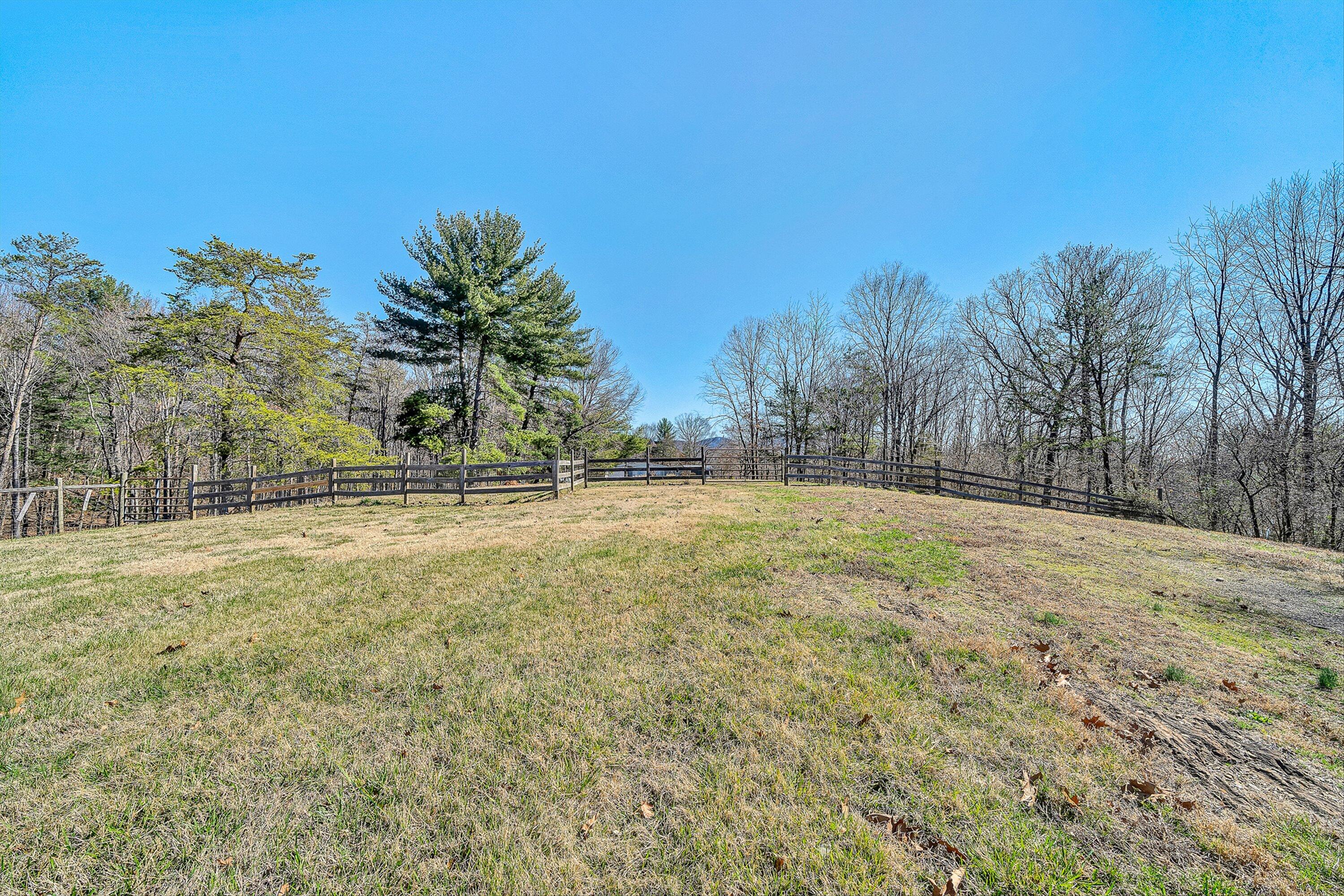 1155 Stonewall Road Blue Ridge, VA 24064 - Photo 29 of 43 a view of dirt field with trees in the background