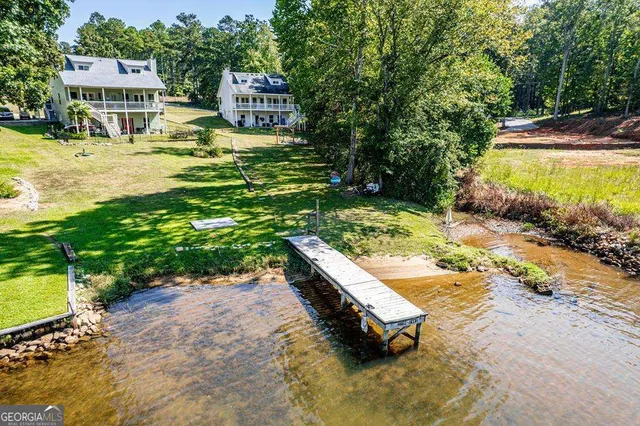 a swimming pool with some tall trees
