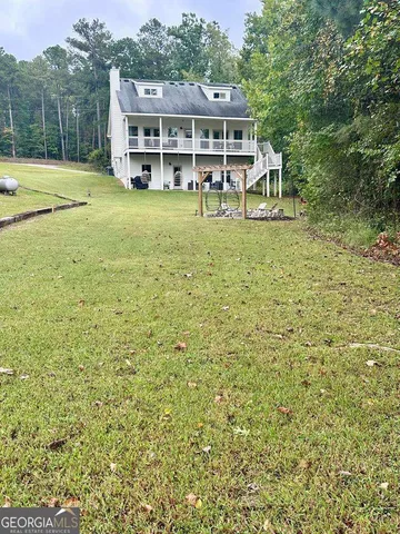 a view of a house with pool yard and balcony