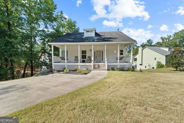 a front view of a house with basket ball court and outdoor seating