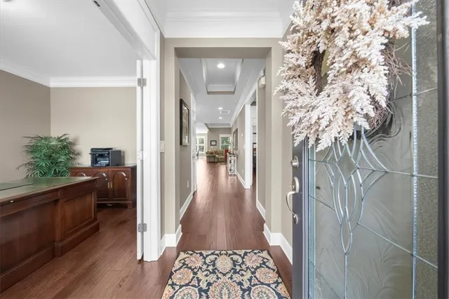 a kitchen with kitchen island wooden floors white cabinets and stainless steel appliances