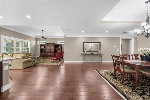 a living room with furniture a window and a flat screen tv