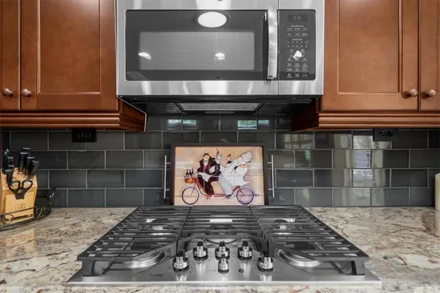 a bathroom with a granite countertop sink shower and a mirror