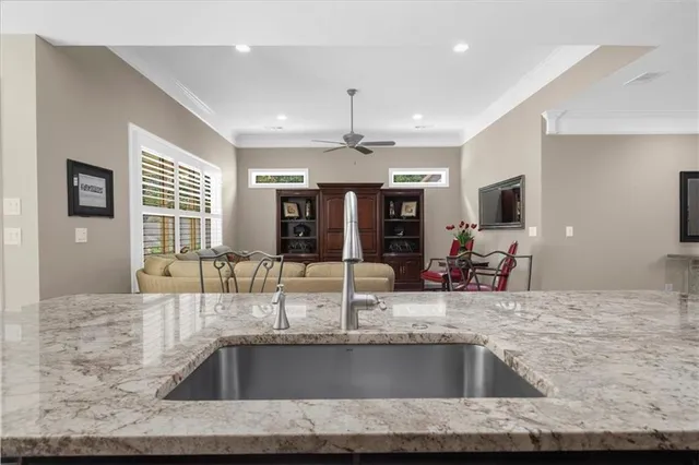 a bathroom with a granite countertop sink and a large mirror