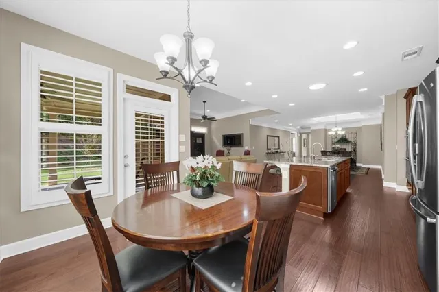 a bathroom with a bathtub sink vanity and mirror