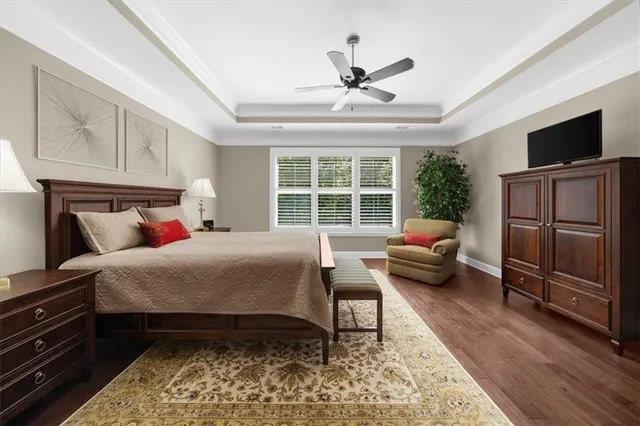 an aerial view of residential houses with outdoor space and trees