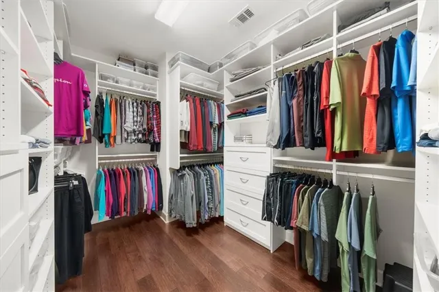 a view of a house with a big yard and potted plants