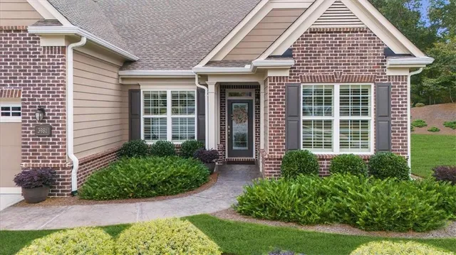 a living room with stainless steel appliances granite countertop furniture wooden floor and a window