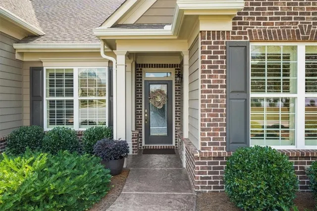 a kitchen with stainless steel appliances granite countertop a stove refrigerator a dining table and chairs with wooden floor