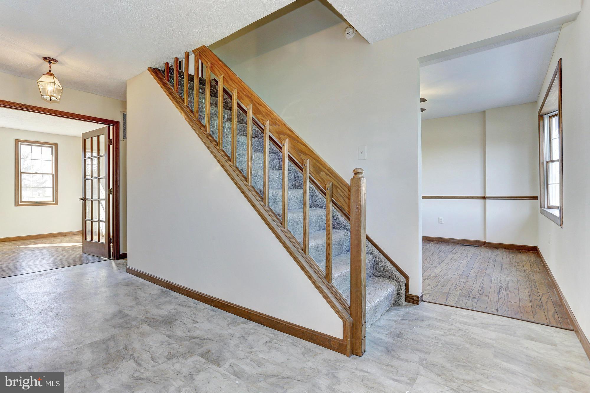 602 Rivershore Court Edgewood, MD 21040 - Photo 3 of 28 a view of an entryway with wooden floor leading to a furnished livingroom and windows