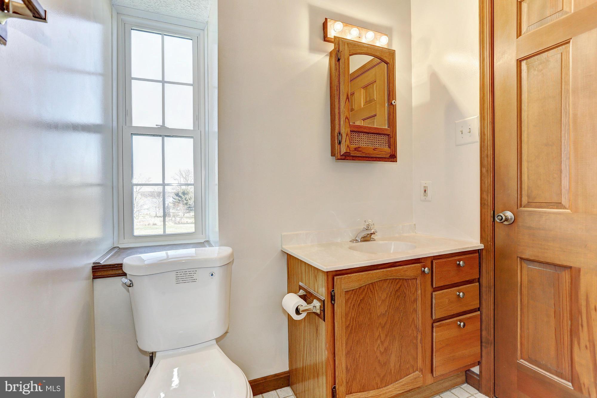 602 Rivershore Court Edgewood, MD 21040 - Photo 21 of 28 a bathroom with a toilet a sink and a window