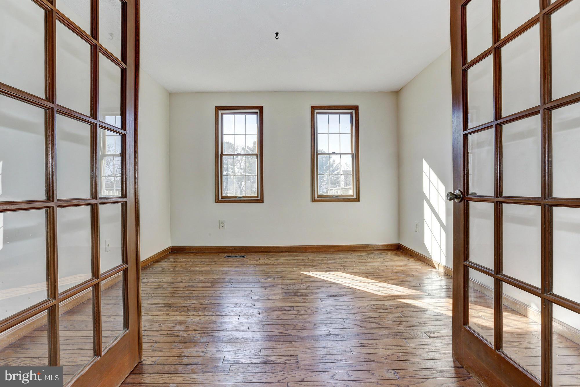 602 Rivershore Court Edgewood, MD 21040 - Photo 4 of 28 a view of an empty room with wooden floor and a window