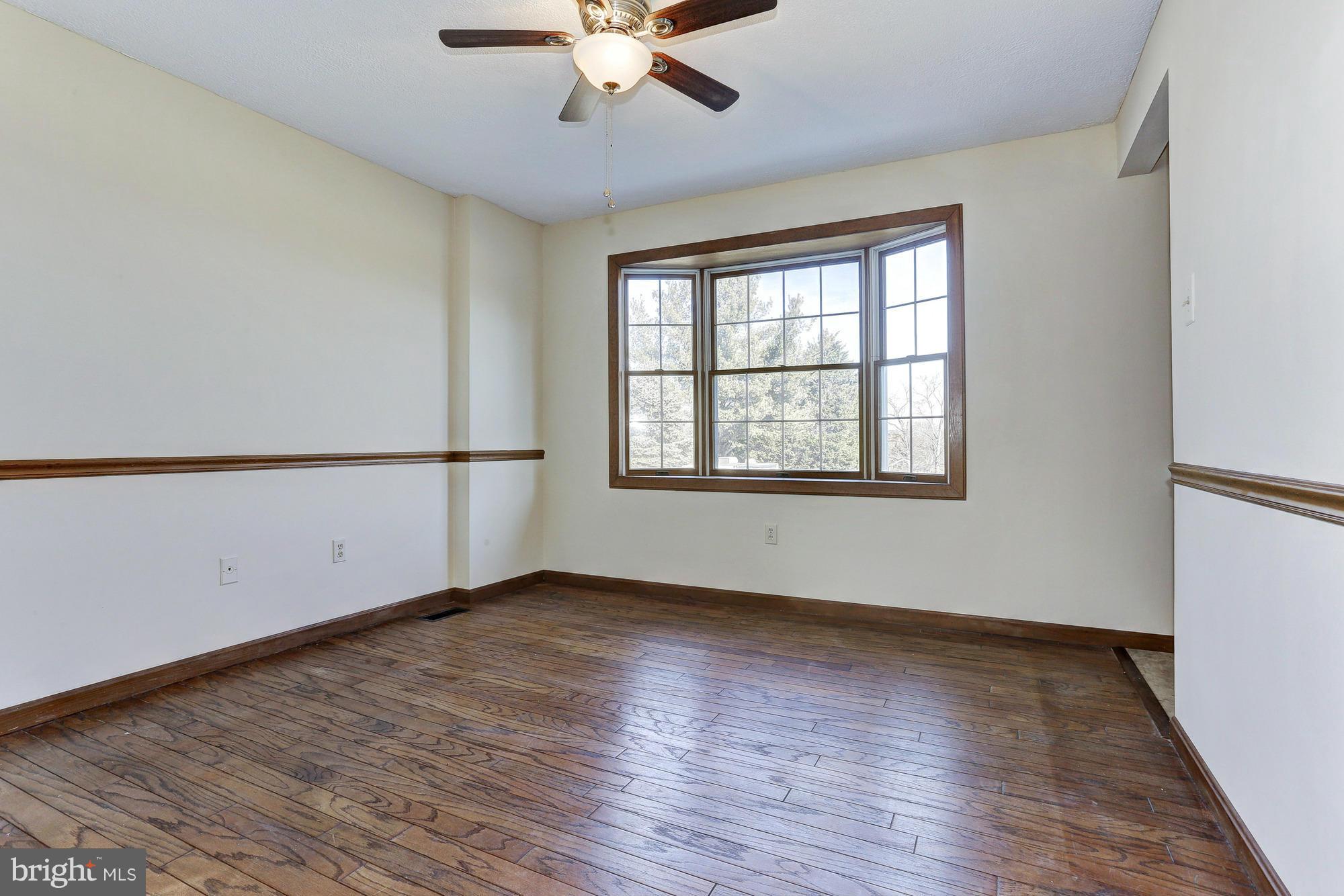 602 Rivershore Court Edgewood, MD 21040 - Photo 5 of 28 an empty room with wooden floor fan and windows