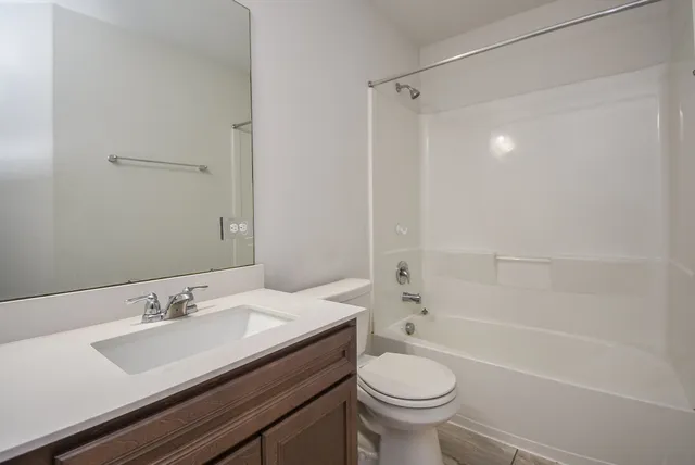 a kitchen with kitchen island granite countertop stainless steel appliances a sink stove and refrigerator
