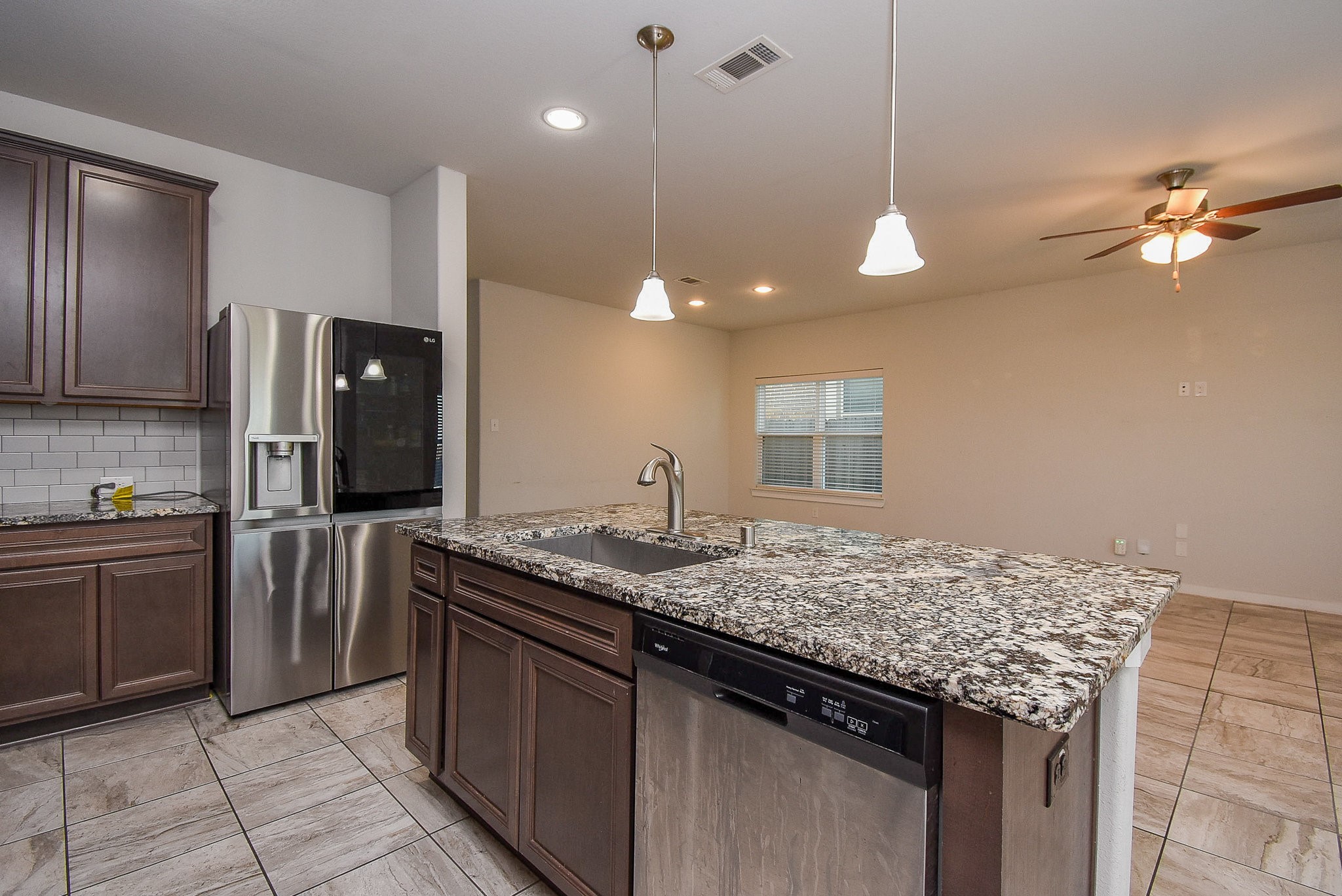 20602 Riley Copper Drive Cypress, TX 77433 - Photo 14 of 32 a kitchen with kitchen island granite countertop stainless steel appliances a sink stove and refrigerator