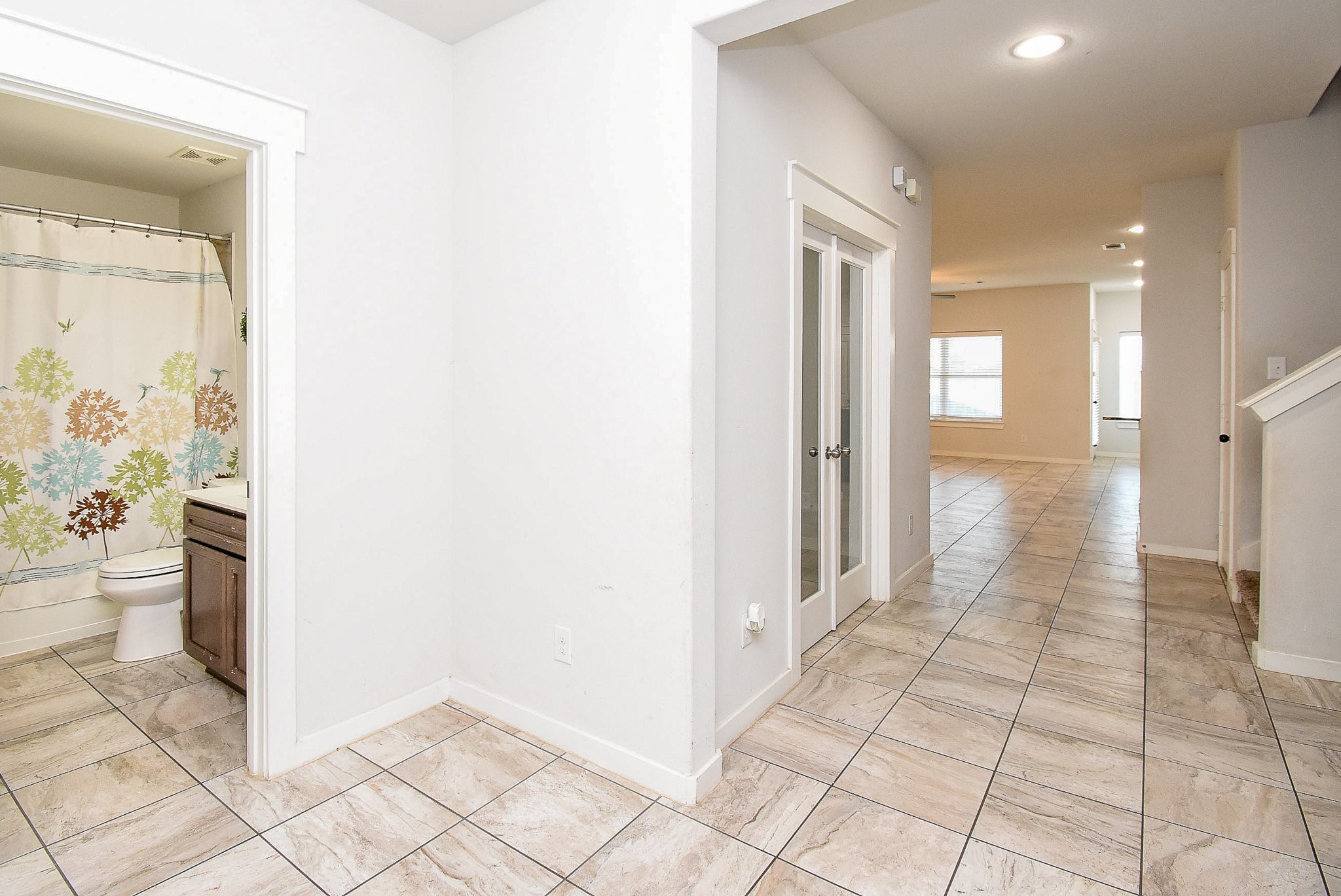 20602 Riley Copper Drive Cypress, TX 77433 - Photo 7 of 32 a view of a hallway with wooden floor and a bathroom