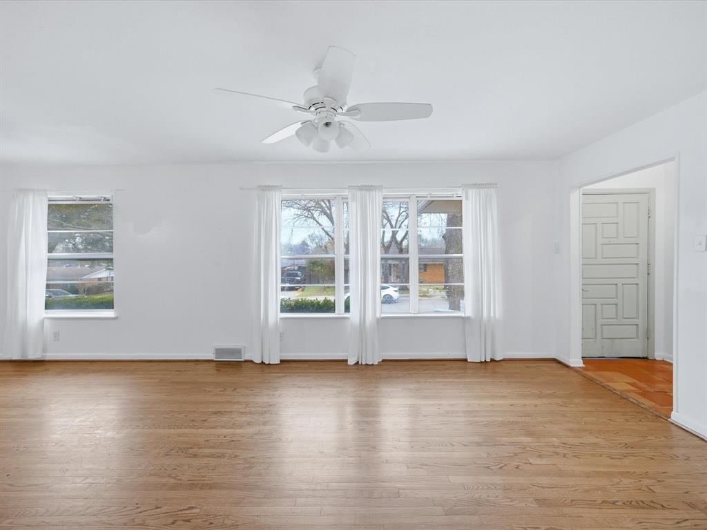514 West Ridgewood Drive Garland, TX 75041 - Photo 14 of 39 a view of livingroom with hardwood floor and window