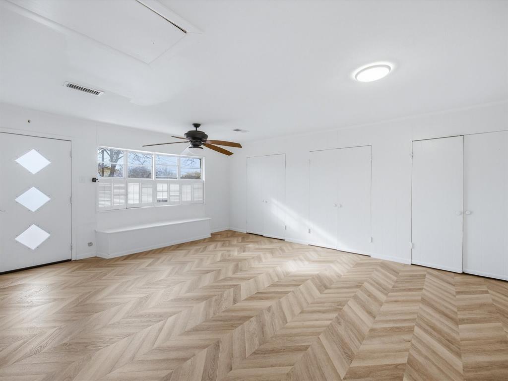 514 West Ridgewood Drive Garland, TX 75041 - Photo 1 of 39 a view of empty room with wooden floor and fan