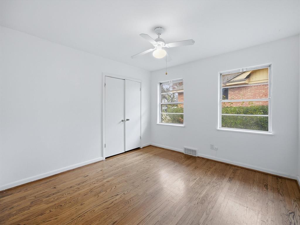 514 West Ridgewood Drive Garland, TX 75041 - Photo 20 of 39 a view of an empty room with wooden floor and a window