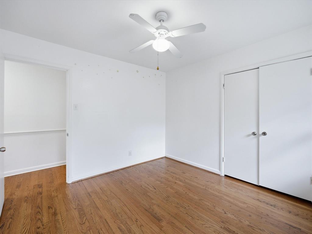 514 West Ridgewood Drive Garland, TX 75041 - Photo 22 of 39 an empty room with wooden floor fan and windows
