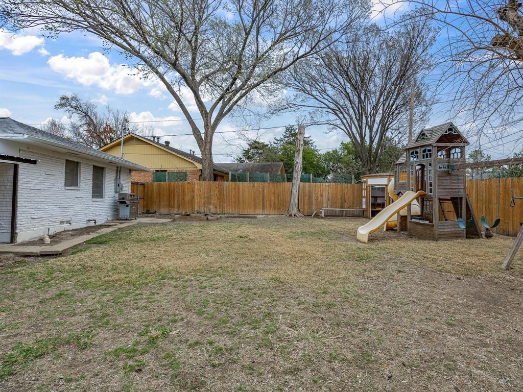 514 West Ridgewood Drive Garland, TX 75041 - Photo 30 of 39 a view of a house with a yard