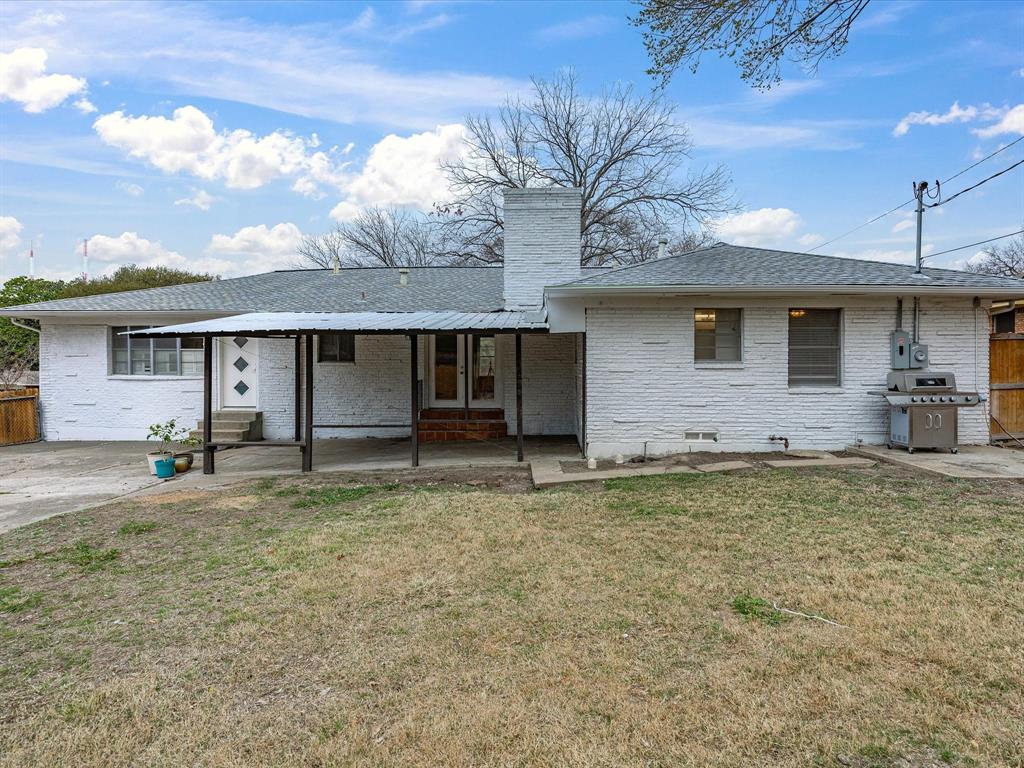514 West Ridgewood Drive Garland, TX 75041 - Photo 33 of 39 a front view of a house with a garden and yard
