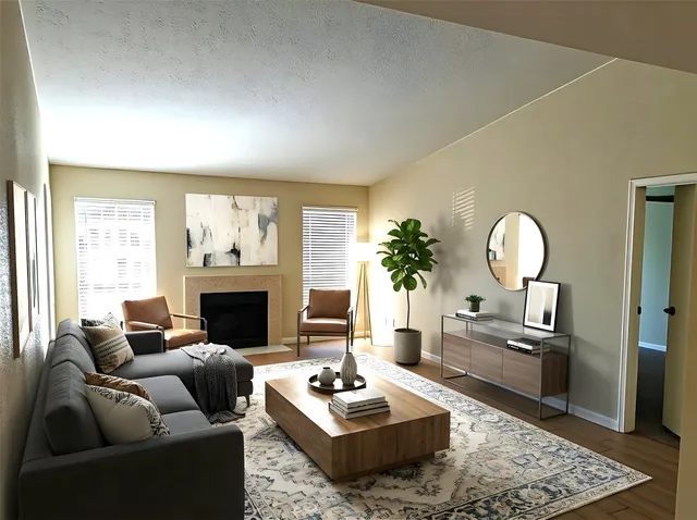 a living room with furniture and a fireplace