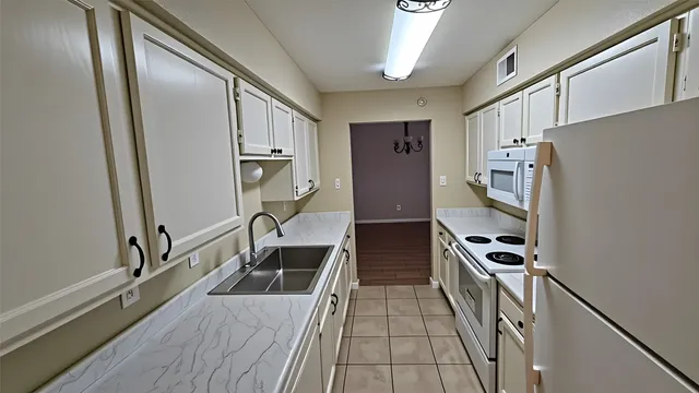a kitchen with stainless steel appliances a refrigerator and a stove