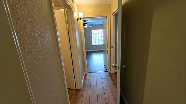 a view of a bathroom from a corridor