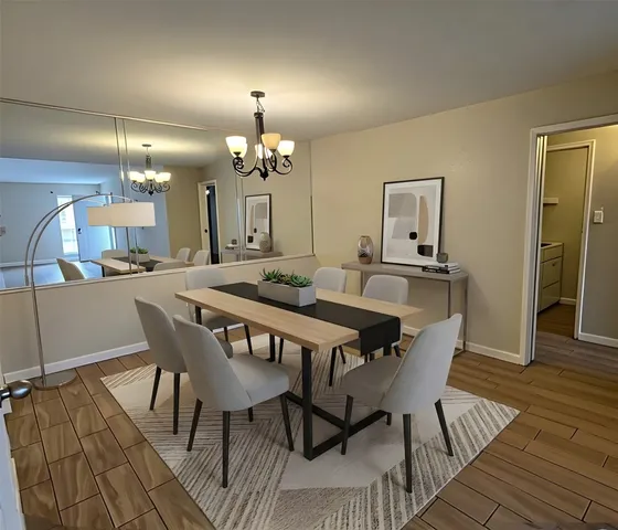 a view of a dining room with furniture and wooden floor